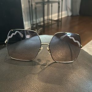 Square oversized Dior sunglasses. Lightly tinted grey/black with gold trim.